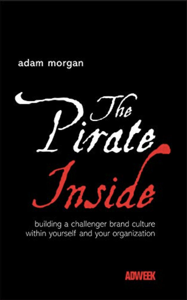 Book cover of the pirate inside in red and white cursive lettering against a black background